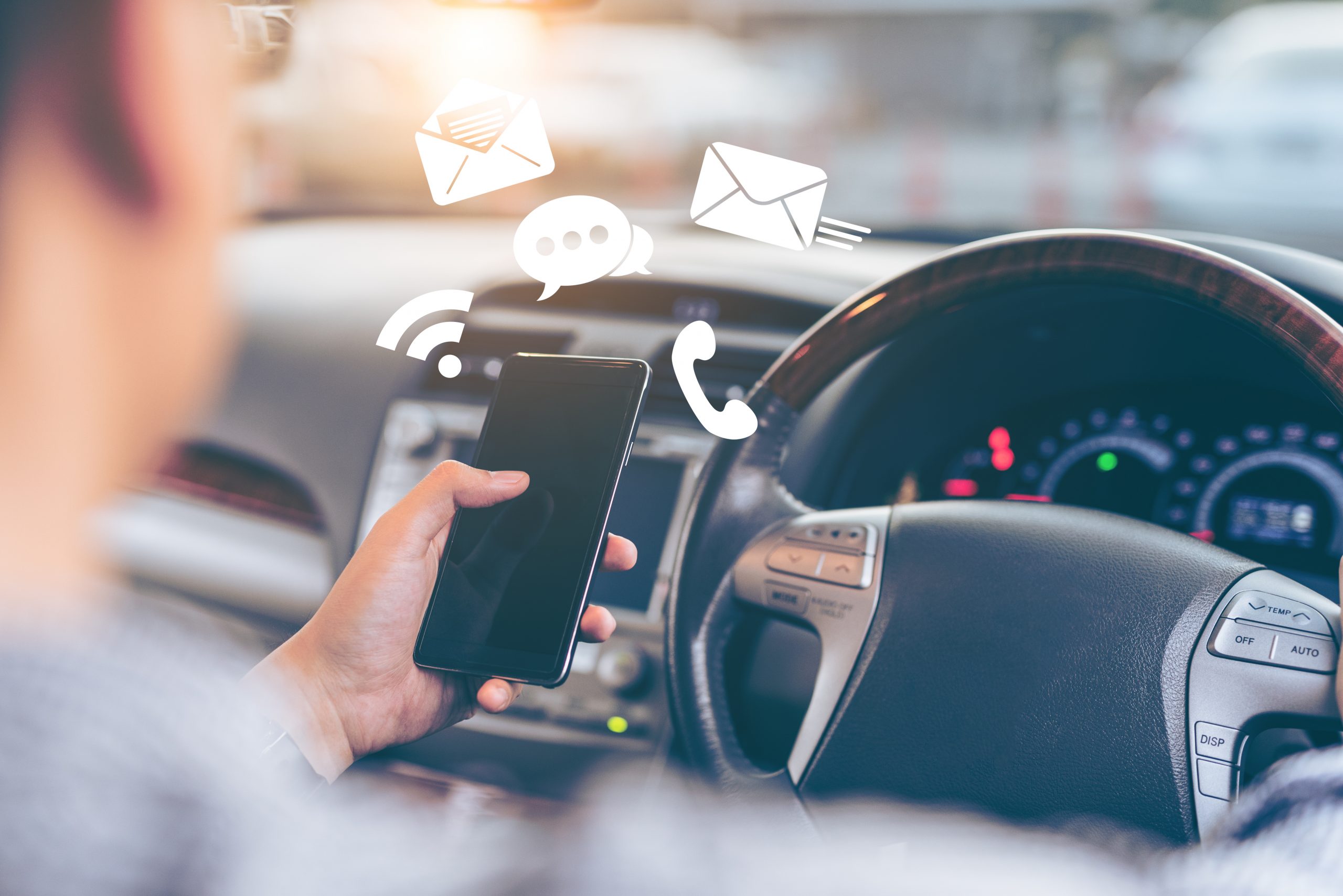 Man using smartphone while driving the car