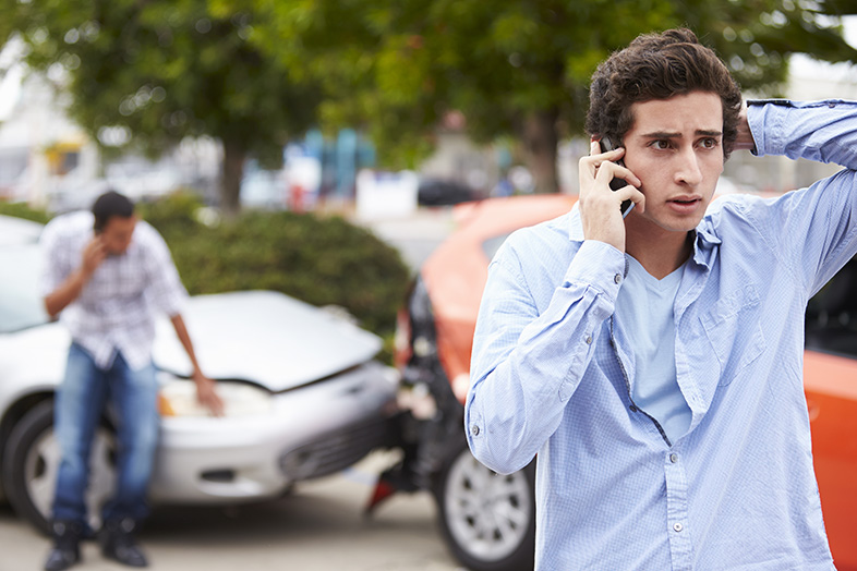 Teen driver on the phone after being in a car accident