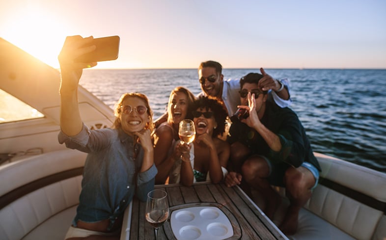 Group of friends drinking on a boat on a Wisconsin lake during the summer