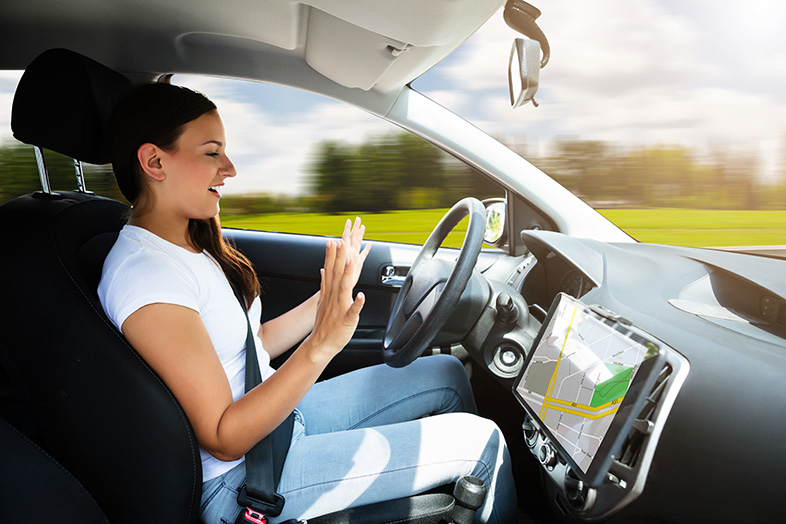 Woman sitting in self-driving car