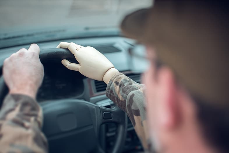 View of returning soldier behind the wheel of a car, veterans at higher risk of being in an accident