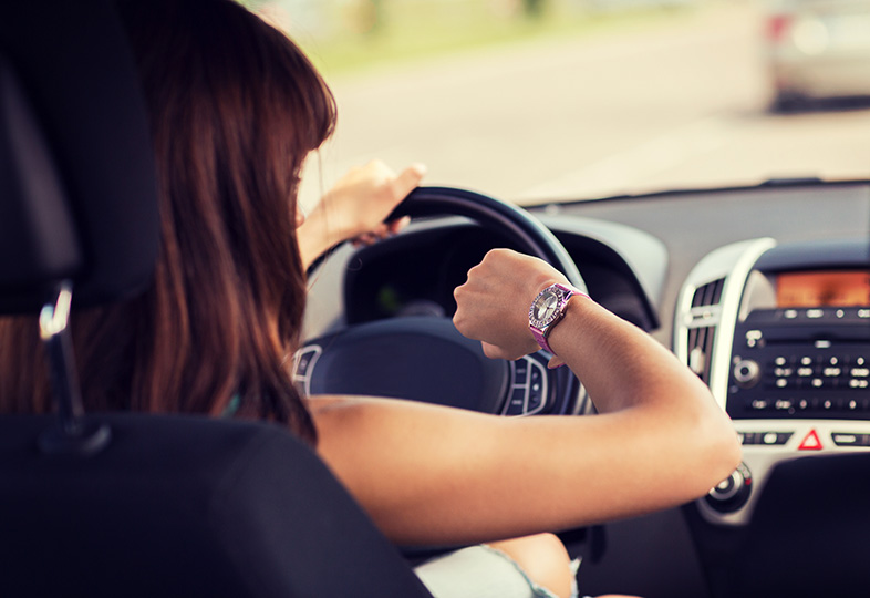 Wisconsin woman checking the time on her watch while driving
