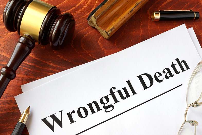 Wrongful death claim on a wooden table next to a pen and gavel
