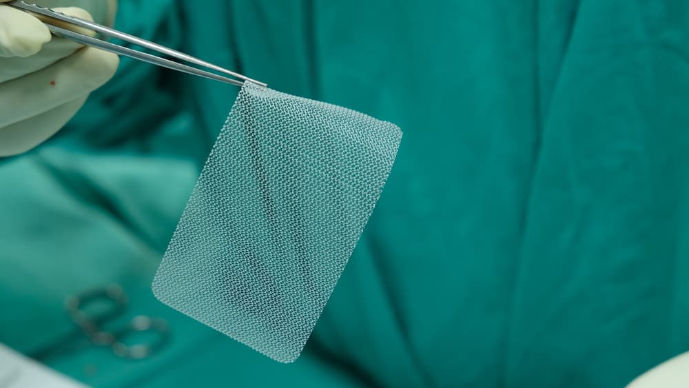 Doctor holding mesh for hernia surgery