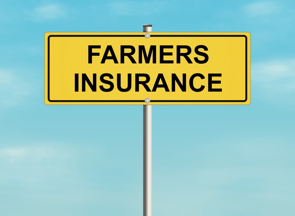 Illustration of a road sign featuring the Farmers Insurance logo against a backdrop of a sky.