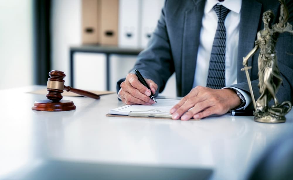 Personal lawyer working in an office or courtroom, with a gavel and legal documents, symbolizing justice and legal counsel.