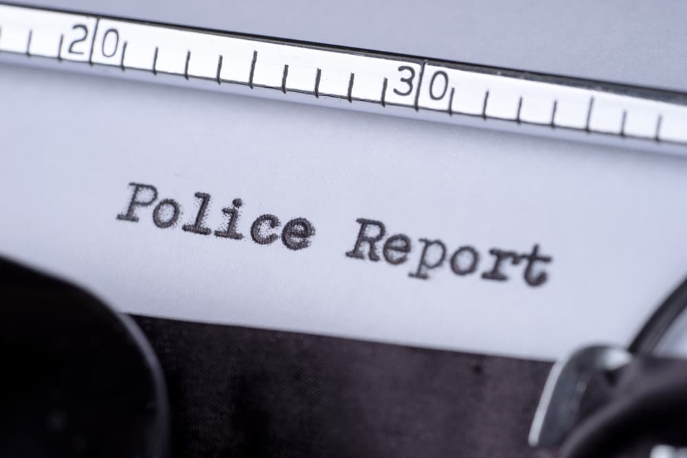 Close-up of a police report being typed, emphasizing the creation of official accident documentation used to evaluate fault after a crash.