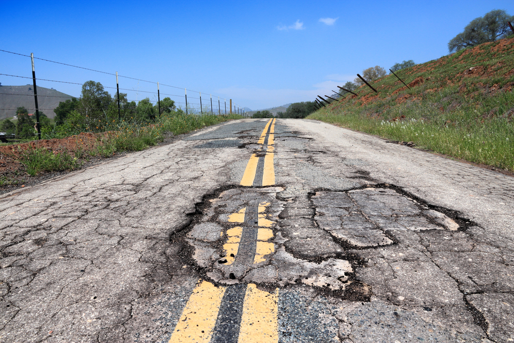 Severely damaged road posing driving risk