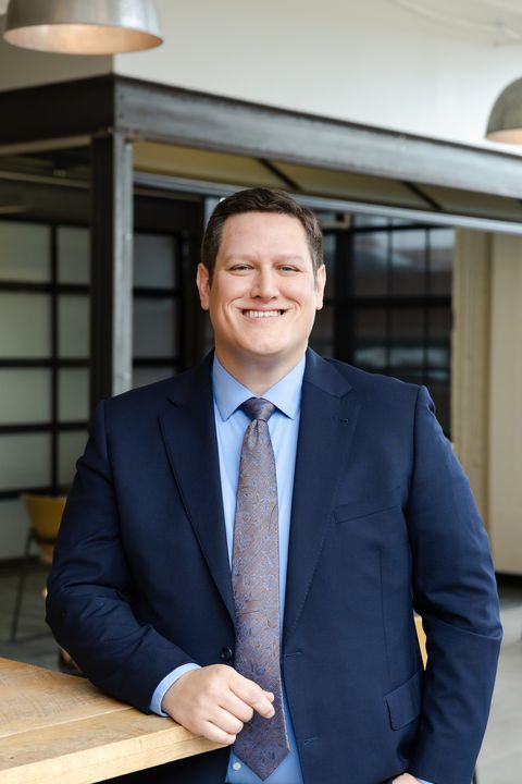 Hunter McKee Indiana Personal Injury Attorney smiling in a navy suit and tie