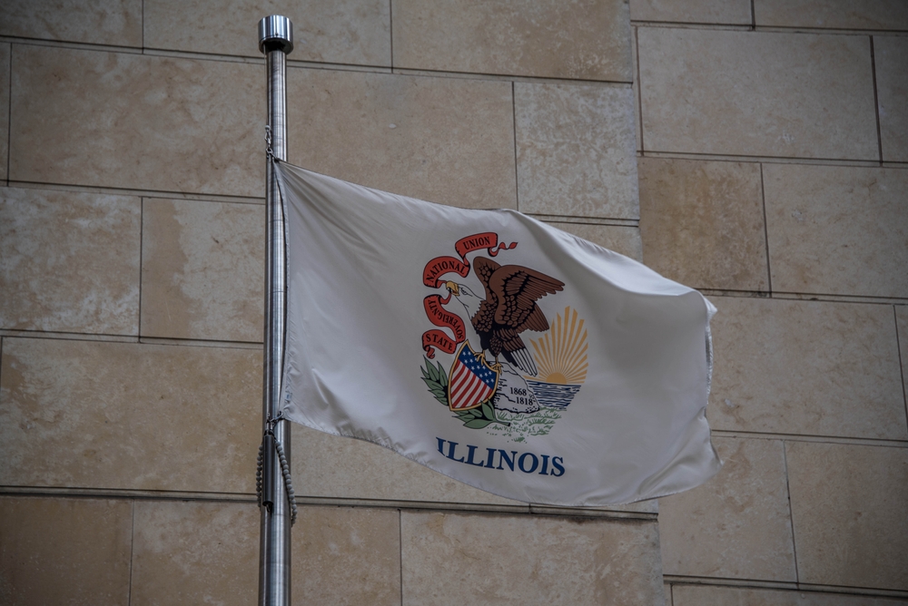 Illinois state flag with seal in front of courthouse
